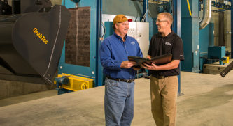 Jason Appel Meets with farmer and signing papers by a tractor