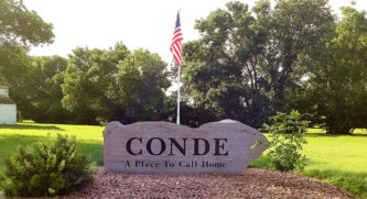 Sign that says Conde, a place to call home in a park